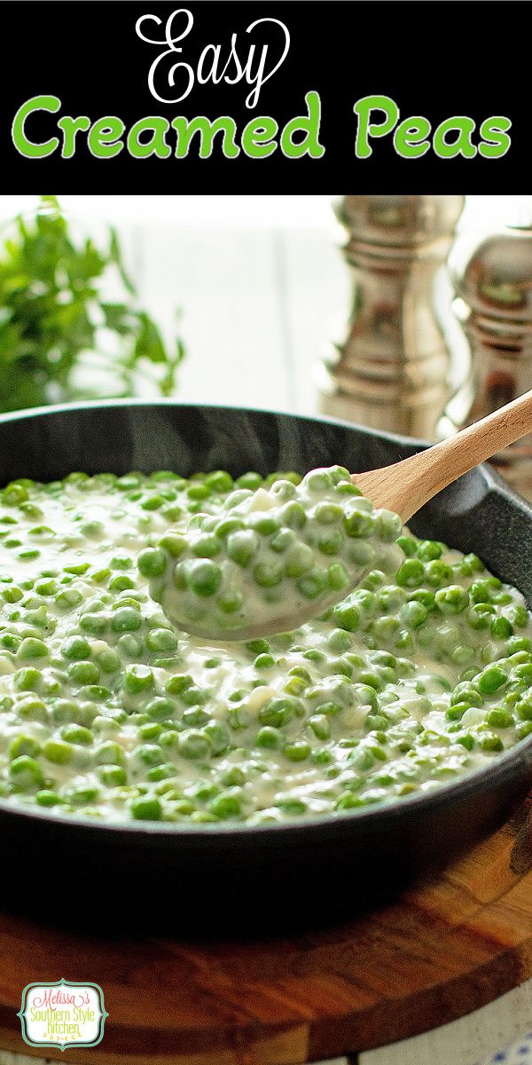 a skillet filled with peas on top of a wooden cutting board