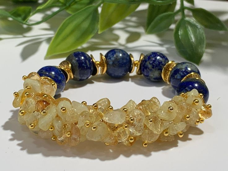 "This Bracelet is made with 12mm, all-natural Lapis Lazuli blue gemstones and all-natural, Grade AA+ Milky white/yellow Brazilian citrine gemstone chips and accented with gold-color spacers. Made with high-quality elastic stretch cord that easily rolls over your hand and wrist.   Matching Earrings:  https://www.etsy.com/listing/1326641249 BRACELET SIZE INSTRUCTIONS  See 2nd Item Photo for a Pictorial Instruction. We make all our bracelets to actual \"wrist size\" (not \"bracelet size\" or \"brac Yellow Spiritual Bracelet With Gemstone, Yellow Spiritual Gemstone Bracelets, Yellow Spiritual Crystal Bracelet Gift, Spiritual Yellow Crystal Bracelet Gift, Yellow Spiritual Gemstone Bracelet, Adjustable Yellow Beaded Bracelets With Natural Stones, Adjustable Yellow Crystal Bracelet With Gemstone Beads, Handmade Spiritual Citrine Bracelets, Yellow Citrine Spiritual Bracelets