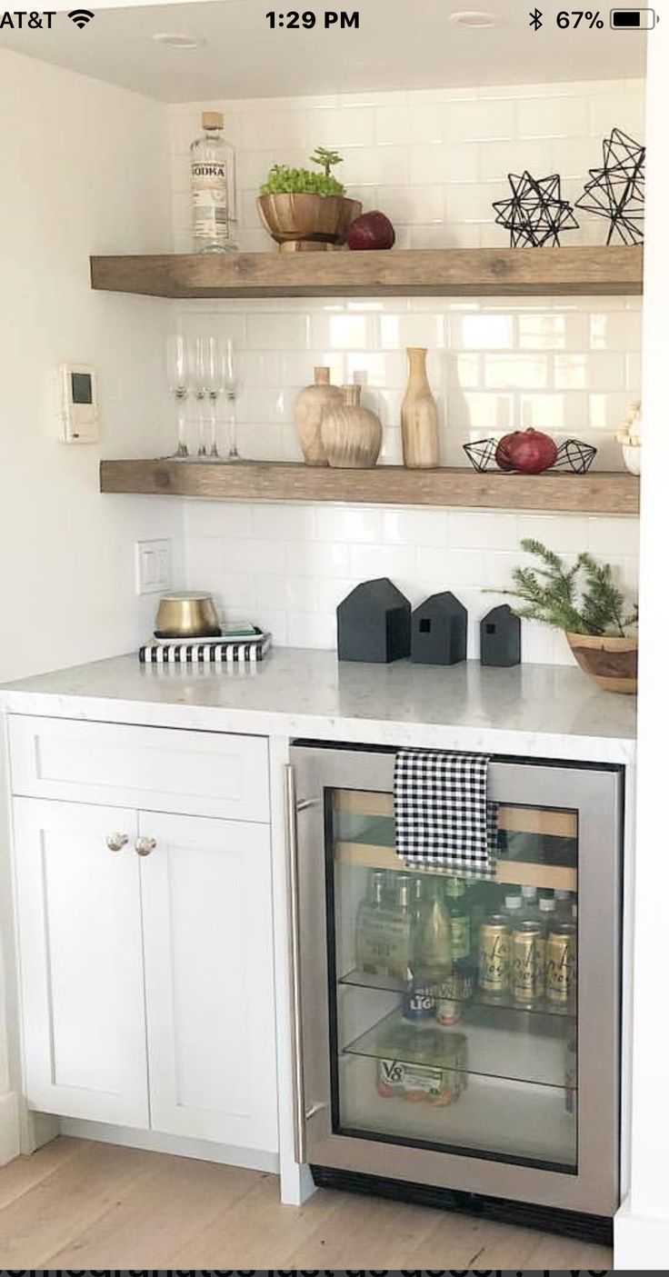 a kitchen with white cabinets and open shelves