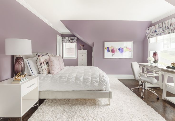 a bedroom with purple walls and white furniture