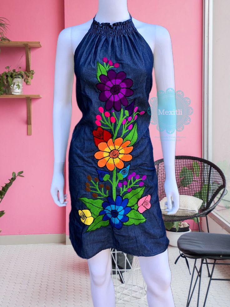 "Floral Embroidered Mexican Halter dress. Made out a lightweight denim. Please note: each dress is unique, the embroidery may be slightly different from the one pictured. Size- Medium Dimensions: Bust- 41\" Hips- 42\" Length- 34\" 🧵Made in Chiapas, Mexico. 🧺Care Instructions: We recommend hand washing, air dry. 📲Please feel free to message me with any questions regarding sizing and fit. 📷Additional photos can be provided upon request. 👗Always allow a little room and consider your own measur Embroidered Fitted Denim Dress, Blue Embroidered Bohemian Denim Dress, Bohemian Embroidered Denim Dress, Blue Bohemian Embroidered Denim Dress, Bohemian Denim Dress With Floral Embroidery For Spring, Blue Fitted Embroidered Cotton Dress, Casual Embroidered Denim Dress, Casual Embroidered Fitted Denim Dress, Casual Fitted Embroidered Denim Dress