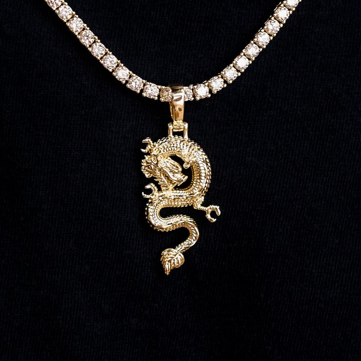 a necklace with a gold dragon on it