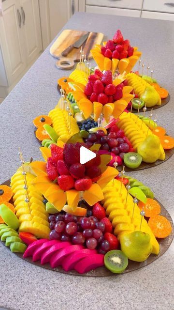 fruit trays are arranged in the shape of an upside down tree on a kitchen counter