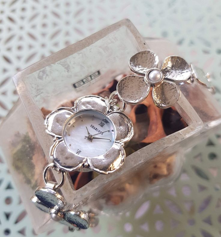 Sterling Silver and Pearl Watch for Woman NEW . Floral design. This watch features high presence and fine taste in high quality silver and unique design, it is perfect for special events also great as a gift! Condition: Brand New, Perfect Finish Metal: Sterling Silver 925 Gender: Ladies Length: 6.5 Inch Features: - Watch by Miyota (movement manufacturing subsidiary of the Citizen) - 3ATM water resistance 12 months warranty! We invite you to our other boutiques: http://www.sterlingsilverjewel.com Elegant Metal Round Watch, Elegant Round Metal Watch, Timeless Silver Jewelry Gift, Timeless Silver Jewelry For Gift, Luxury Metal Watches As Gift, Luxury Silver Jewelry And Watches For Wedding, Silver Watch With Bracelet Strap And Round Dial, Timeless Metal Jewelry And Watches For Gifts, Luxury Silver Jewelry Gift For Her