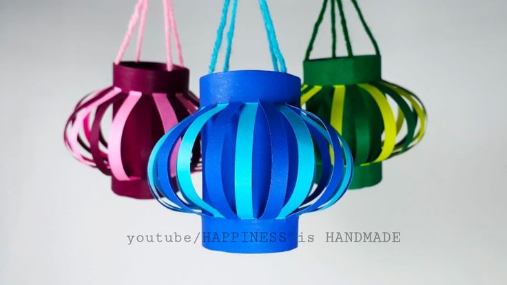 three colorful paper lanterns hanging from strings