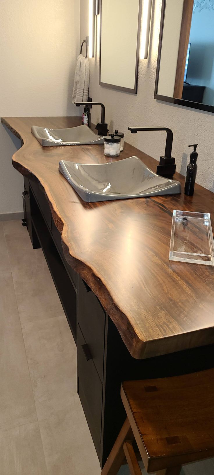 a bathroom with two sinks and mirrors on the wall