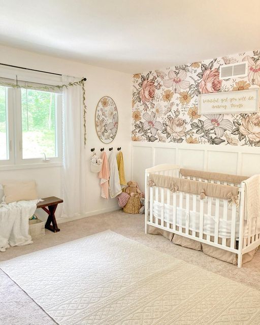 a baby's room with floral wallpaper and white crib