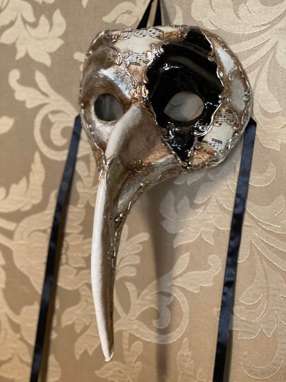 Plague doctor's mask made entirely of papier-mache and hand-decorated with acrylic colors.All our masks are handmade by our staff (me, my wife and our collaborators) in our atelier in Venice. The masks are all made of paperweight and are made using ancient techniques from the 1300sThey are decorated with acrylic colors, gold leaf, silver leaf, trifies, lace and Swarovski crystals so as to make them more valuable.We are a small family business and have been laboratorying in Venice for more than 2 Artistic Masks For Halloween Costume Party, Artistic Halloween Mask For Costume Party, Artistic Masks For Masquerade And Halloween, Artistic Masks For Halloween Masquerade, Artistic Halloween Masquerade Masks, Artistic Masks For Carnival Themed Events, Artistic White Masks And Prosthetics For Halloween, Artistic White Masquerade Mask For Halloween, Halloween Eye Mask As A Gift