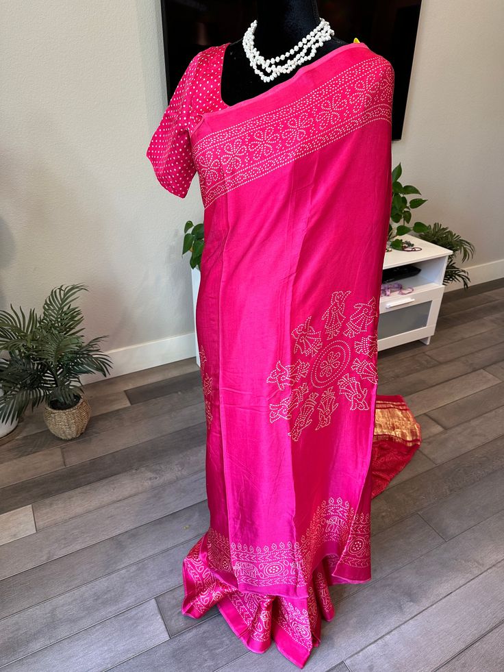 Gajji silks are known for their softness and pallu. This pure gajji silk saree is a beautiful pink shade and cones with white bandhni digital prints all over. The saree is very soft to touch and is flowy. Pallu is a lagdi patta and can be draped easily. Blouse is fully stitched and is open with hooks and dori at the back. Blouse is size adjustable from 36-44 inches (with margins inside) Falls/pico are already done and saree is ready to wear. Size 36-44 adjustable stitched blouse : Pure gajji silk saree with bandhni prints and lagdi patta pallu | gajji silk sarees online shopping | ethnic Pink Bandhani Print Pre-draped Saree For Festivals, Navratri Batik Print Saree, Pink Block Print Saree For Navratri, Slub Silk Pre-draped Saree With Bandhani Print For Puja, Slub Silk Bandhani Pre-draped Saree For Puja, Festive Batik Print Art Silk Saree, Pink Block Print Saree For Diwali, Tussar Silk Saree Blouse Piece With Bandhani Print, Pink Bandhani Print Chanderi Pre-draped Saree