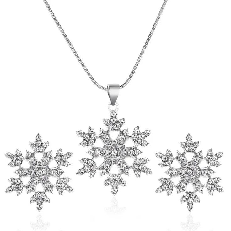 Dazzle with the celestial elegance of our Austrian Crystal Snowflake Flower Pendant Necklace & Earrings Set, offering six unique options of stud or dangle earrings. Inspired by the delicate beauty of snowflakes and flowers, this exquisite set exudes timeless charm and sophistication. Crafted with precision and adorned with shimmering Austrian crystals, each piece sparkles with ethereal allure, capturing the essence of winter's enchantment. The pendant necklace features a captivating snowflake flower design, suspended from a delicate chain, adding a touch of celestial grace to any neckline. With six stunning earring variants to choose from—ranging from delicate studs to elegant dangles—this set offers versatility to suit any style or occasion. Whether you prefer the subtle sophistication of Heavy Highlights, Snowflake Jewelry, Snowflake Necklace, Double Heart Necklace, Snowflake Earrings, Snowflake Design, Mens Jewelry Necklace, Zircon Jewelry, Fashion Jewelry Sets