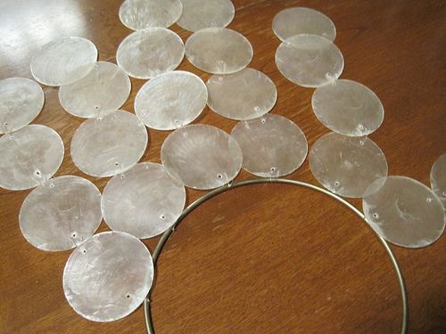 a bunch of glass discs sitting on top of a wooden table