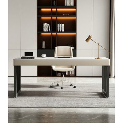 an office desk in front of a bookcase with bookshelves on the wall