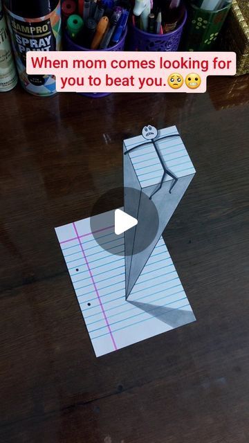 a piece of paper with an origami figure cut out of it sitting on top of a table