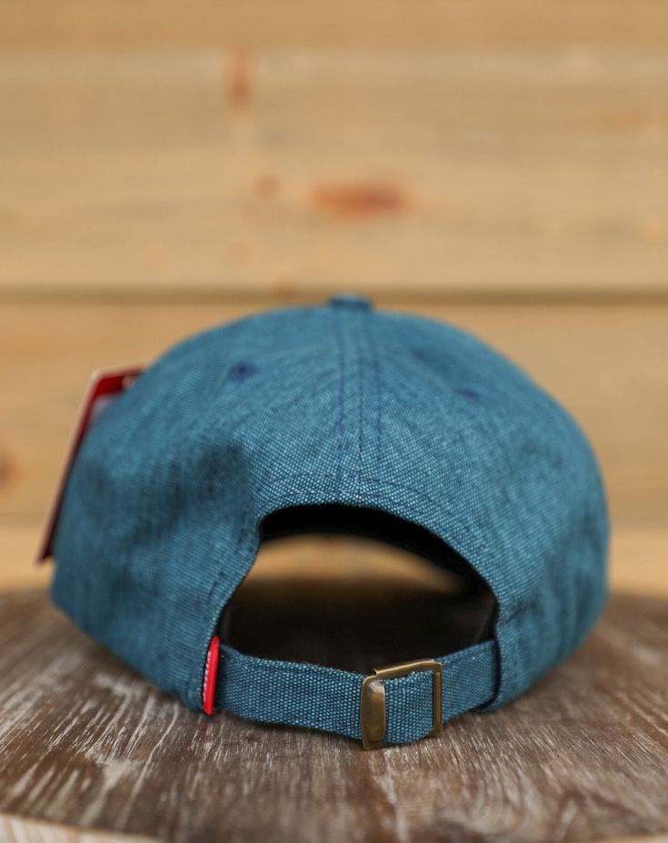 Mini Hux Blue Kimes Ranch Trucker Hat The Mini Hux blue Kimes Ranch mid-profile trucker hat is one with soft construction that every cowgirl or cowboy will love! This mid-profile OSFA Dad hat is adorned with white and gold Kimes Ranch stitched logo embroidery on front panel, blue garment washed cotton canvas front and back, and curved brim. Features an adjustable self strap and buckle closure to ensure the perfect fit! Product Details Blue Cotton Twill Front and Back Curved Bill White Mesh Back Kimes Ranch Stitched Logo Embroidery Adjustable Self Strap and Buckle Closure Mid-Profile One Size Fits All Sizing - One Size Fit - Mid-Profile Hat Shipping - Our store is located in San Tan Valley, Arizona, and packages typically ship within 1-3 business days after you place your order. Free shippi Adjustable Rodeo Cap, Adjustable Casual Baseball Cap For Rodeo, Casual Adjustable Fit Hat For Rodeo, Denim Blue Hat With Curved Brim, Casual Blue Hats For Rodeo, Blue Adjustable Trucker Hat With Short Brim, Country Style Snapback Hat With Curved Brim, Blue Snapback Trucker Hat For Rodeo, Rodeo Baseball Cap With Curved Bill