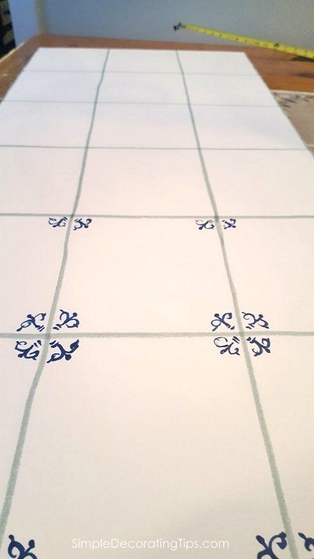 a table with blue and white tiles on it, ready to be cut into pieces