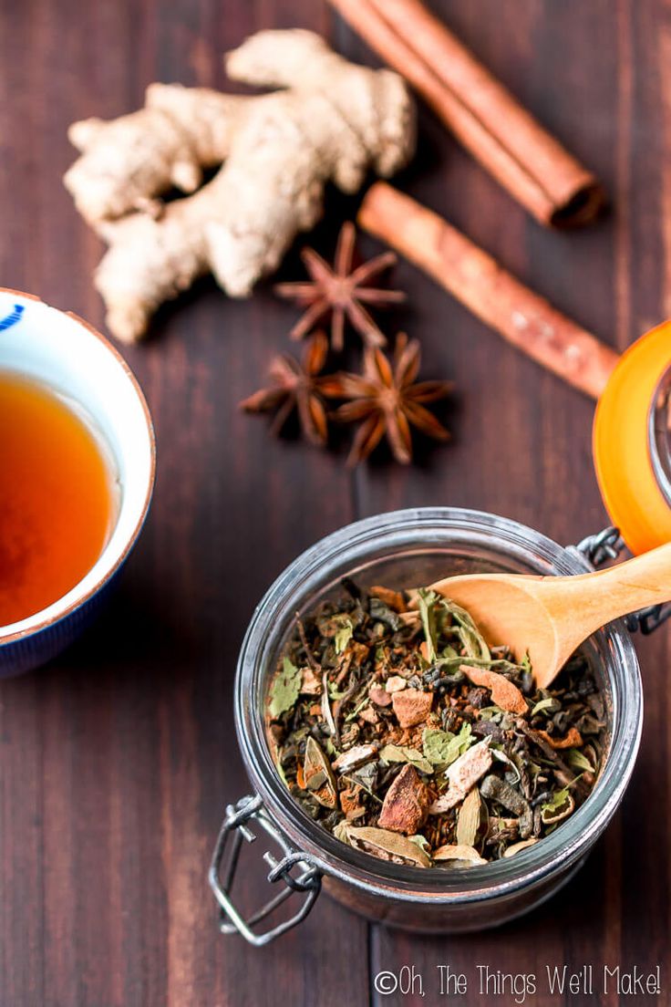 an assortment of teas and spices on a wooden table