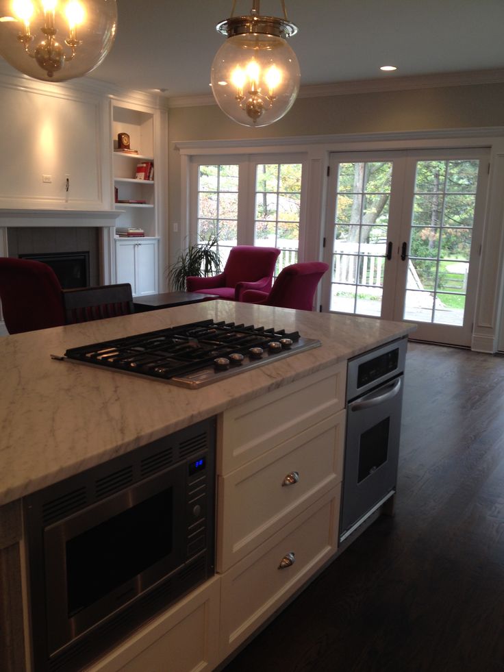 a kitchen with an island and stove top oven