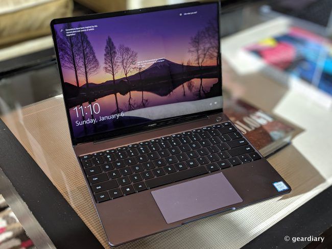 an open laptop computer sitting on top of a glass table