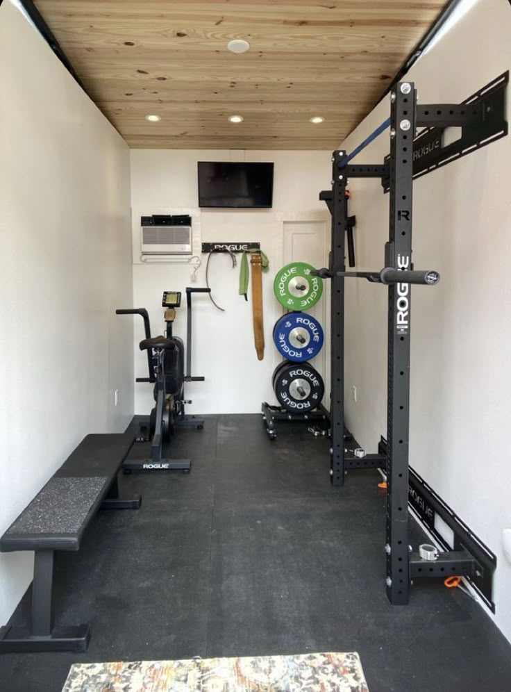 the inside of a home gym with equipment