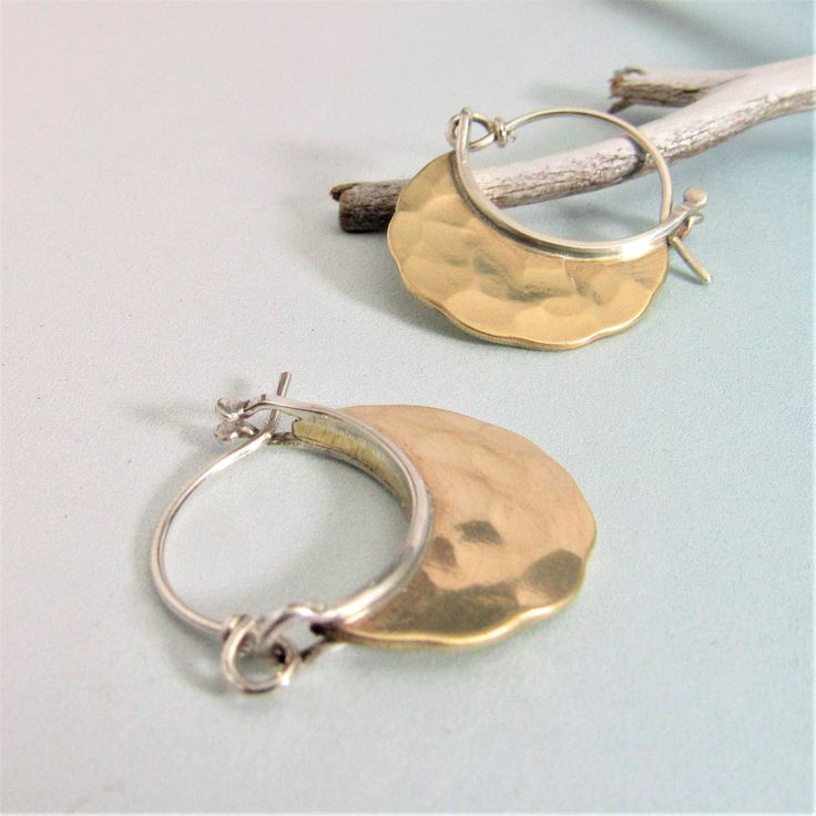 "Small forged bronze (nu-gold) hoop earrings with sterling silver ear wires. A beautiful gold color without the gold price! Forged for wonderful texture and polished to a gleam this is a pair you will reach for time and time again. A great choice for a lightweight easy to wear pair that compliments any and everything you wear. Jewelers bronze also known as nu-gold is an economical choice for a true golden color. The pair in the photo has a bright finish although we can make you an oxidized pair Gold Hammered Crescent Hoop Earrings, Gold Hammered Crescent Earrings, Gold Crescent Hoop Earrings With Hammered Detail, Gold Crescent Hammered Earrings, Artisan Hammered Dangle Hoop Earrings, Artisan Gold Hoop Earrings With Hammered Detail, Gold Electroformed Hoop Earrings, Gold Electroformed Brass Hoop Earrings, Bronze Hammered Hoop Earrings