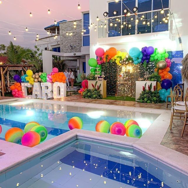 an indoor pool decorated with balloons and streamers