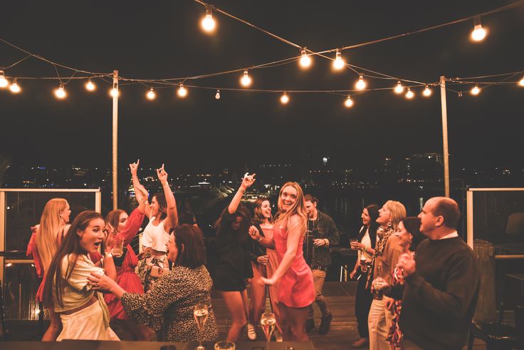 a group of people standing on top of a roof