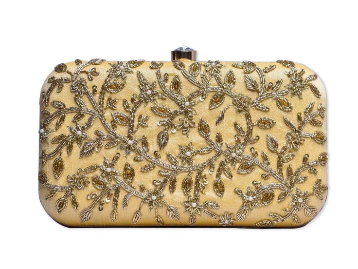 Embroidered Yellow Clutch Bag with Detachable Chain Strings Adorned with some stunning gold zardozi work accented with pearls the Sweetsun clutch is all you need to enamor everyone at any event you attend. Fabric Raw Silk Color Light Yellow Embroidery Gold zardozi metal pipework with pearls Size amp Dimensions Height - 5 inWidth - 8 inDepth - 1.5 in Fits most of the phones. Strap Detachable shoulder strap made of golden metal chain Closure Compartment button closure Compartments Single compartme Festive Beige Rectangular Evening Bag, Festive Beige Rectangular Shoulder Bag, Rectangular Shoulder Bag For Receptions And Festivals, Beige Clutch Evening Bag For Festive Occasions, Festive Embellished Beige Clutch, Festive Beige Embroidered Clutch, Beige Embroidered Evening Clutch, Festive Beige Evening Clutch, Evening Potli Bag With Gold Embroidery