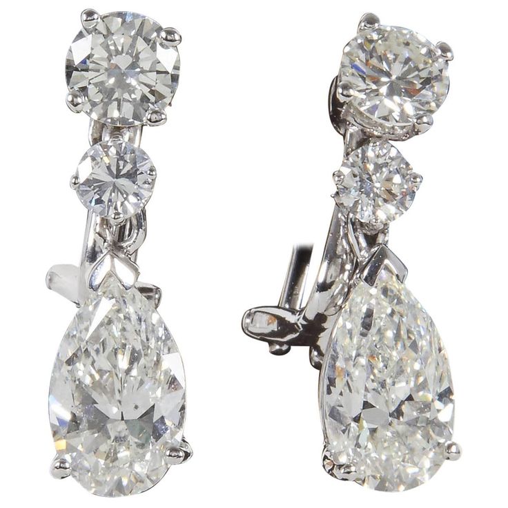 A beautiful pair of classic diamond dangle drop earrings set in a timeless design. 3.00 cts (total) of pear shapes suspended from 1.30 carats (total) of round brilliant cut diamonds. The diamonds are near colorless white, H/I VS1-SI1. The pear shape drops are certified by GIA. Set in 14k white gold. Approximately 2 cm in length. Made by Diamond Scene in New York Heart Shaped Diamond Earrings, Pear Shapes, Argyle Pink Diamonds, Diamond Shape Earrings, Swirl Earrings, Diamond Dangle Earrings, Heart Shaped Diamond, Fancy Diamonds, Pear Diamond