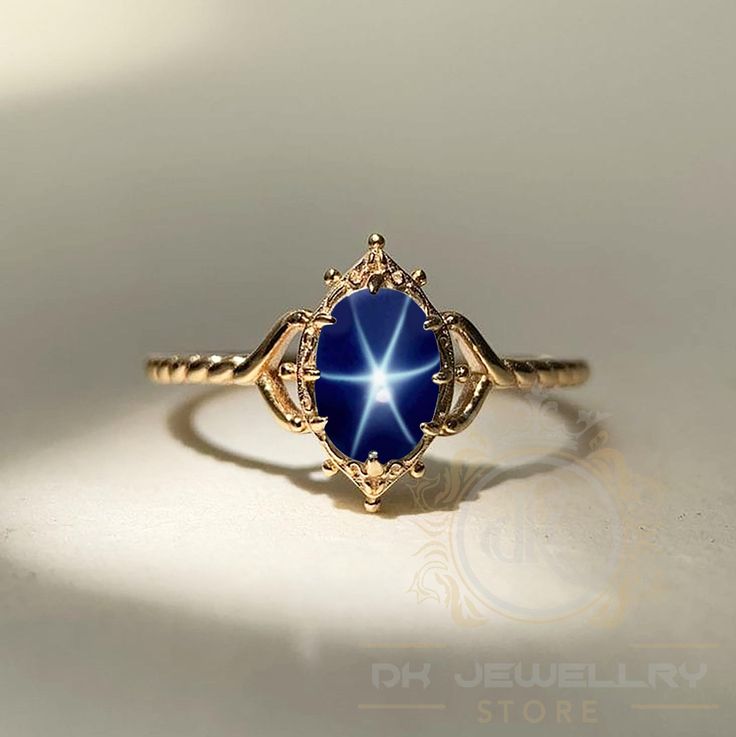 14k Yellow Gold Blue Star Sapphire Ring - Lindy Star Gemstone Jewelry, Perfect Gift for Her ★ Settings ☆ Metal - 925K Sterling Silver ☆ band Color - Rose / White / Yellow ⍟ The ring size shown in the pictures is 8 US. ★ Main Stone ☆ Stone - Lab Created blue star sapphire ☆ Size - 6×8 mm ☆ Shape - Oval ☆ Color Grade- AAA ☆ Certificate of Authenticity and lifetime warranty by Dkjewelrystore ★ Features : ☆ Handmade & Made to order. ☆ Ready to ship in 2-3 Business days. ☆ Complimentary gift wrapping Midnight Blue Star Ring, Sapphire Ring Aesthetic, Elegant Star-shaped Sapphire Promise Ring, Fine Jewelry Star-shaped Gemstone, Celestial Yellow Gold Jewelry With Center Stone, Star-shaped Gemstone Fine Jewelry, Fine Jewelry Star Shaped Gemstone, Star Shaped Gemstone Fine Jewelry, Star-shaped Gemstone Rings For Gifts