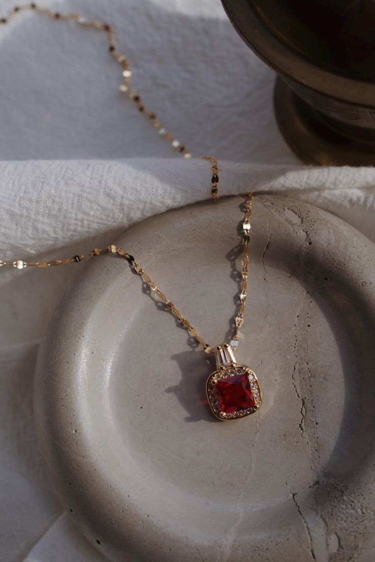 Embody the dark allure of Adeline's mysterious charm with this blood-red pendant necklace ( I like to think it's a little bit of Zade blood ) A piece that captures the essence of her haunting beauty and strength.  OFFICIALLY LICENSED* Ruby Clavicle Chain Jewelry Gift, Ruby Clavicle Chain Jewelry As Gift, Red Pendant Jewelry As A Gift For Her, Red Pendant Jewelry As Gift For Her, Red Ruby Jewelry Gift For Her, Valentine's Day Jeweled Pendant Necklace, Red Clavicle Chain Necklace For Party, Red Clavicle Chain Necklace For Valentine's Day, Elegant Red Necklace With Square Pendant