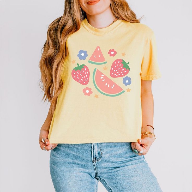 Looking for a cute versatile top to wear? Make sure to grab one of our Graphic tees! This soft and comfortable graphic tee is the perfect top for any outfit. It can be paired with biker shorts, jeans, or even a simple skirt/dress! This tee is true-to-size, so be sure to order your regular t-shirt size! If you are looking for a more oversized look, make sure to size up! Funny Print Graphic Tee Cropped T-shirt, Summer Cropped T-shirt With Funny Print And Crew Neck, Trendy Short Sleeve Tops With Funny Print, Cute Tops With Fruit Print For Spring, Relaxed Fit T-shirt With Fruit Print For Spring, Spring Graphic Tee Cotton Tops, Spring Graphic Cotton Tee, Spring Cotton Graphic Tee Tops, Playful Tops With Funny Print For Spring