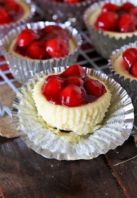 small desserts with cherries in tin cups on a cooling rack, ready to be eaten