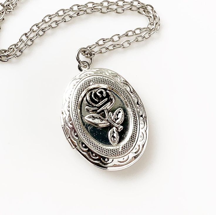 "Rose Locket Necklace Silver Photo Locket Floral Jewelry -I make this necklace using an antique silver chain and locket and rose -Pick any chain length from the dropdown menu- if you don't see your desired length, select \"custom\" and leave the length you need in the \"note to seller\" at checkout -The locket measures 1 3/8\" tall x 1\" across closed. with space for two photos inside -Nickel free and lead free alloy metal -Gift Boxed More of my Rose Jewelry: https://www.etsy.com/shop/lydiasvint Rose Locket, Locket Necklace Silver, Silver Locket Necklace, Mom Wedding Gift, Cameo Jewelry, Floral Jewelry, Wedding Gifts For Bridesmaids, Cameo Necklace, Rose Jewelry