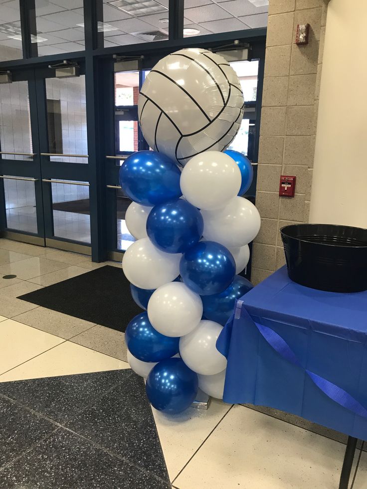 a basketball themed balloon column with blue and white balloons in the shape of a ball