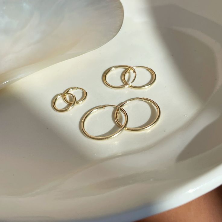 These sweet and delicate little hoops are the newest addition to our earring collection. Simple + effortless, our Goldie Hoops are a favorite for everyday style. MEASUREMENTS Available in 14k Gold Fill or Sterling Silver in 10mm, 14mm, or 16mm diameter14k Rose Gold Fill available in 16mm diameterChoose between a single earring or a pair. Everyday 14k Gold Filled Huggie Earrings, Delicate Small Hoop Earrings For Everyday, Tiny Hoop Huggie Earrings For Everyday, Nickel Free 14k Gold Filled Cartilage Earrings For Everyday, Nickel-free 14k Gold-filled Cartilage Earrings For Everyday, Everyday Nickel-free 14k Gold-filled Cartilage Earrings, Delicate Everyday Huggie Cartilage Earrings, Dainty Everyday Small Hoop Huggie Earrings, Dainty Huggie Cartilage Earrings For Everyday