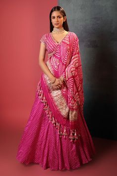 Pink attached can-can silk lehenga with all over bandhani pattern. Paired with a padded floral gota embroidered blouse and bandhani dupatta, highlighted with gota and cutdana. Components: 3 Pattern: Woven, Embroidery Type Of Work: Bandhani, Gota Neckline: V Neck Sleeve Type: Short Sleeves Fabric: Silk Color: Pink Other Details: Lehenga: Attached can-can Gota embroidered broad waistband Length: 42 inches Blouse: Padded Back tie-up detailing Length: 14 inches Dupatta: Beaded and tassel work borde Bandhani Pattern, Orang India, Long Blouse Designs, Bandhani Dress, Lehenga Designs Simple, Indian Bride Outfits, Anarkali Dress Pattern, Gaun Fashion, Indian Dresses Traditional