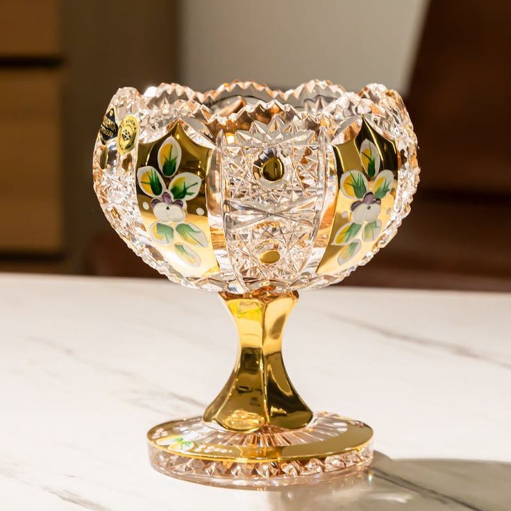 a glass vase sitting on top of a white table next to a brown drawer with drawers in the background