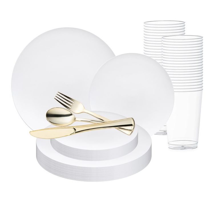 a table setting with goldware, plates and silverware on white plates next to each other