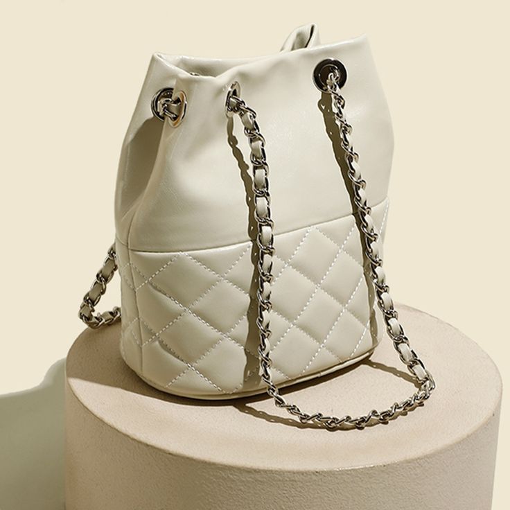 Strike the perfect balance between chic and cool with our quilted bucket bag. Featuring a relaxed, circular silhouette, this roomy piece will ensure that you will have ample space to hold your daily essentials and more with ease. The soft quilted finish is a timeless classic that will never go out of fashion — it will also add visual interest to your look. Pair it with a white lapel blouse, tapered jeans and loafers.Weight: 460 gWidth (cm): 18 cmHeight (cm): 22.5 Color: WhiteInterior Material: C Chic Quilted Tote Bags, Chic Cream Quilted Shoulder Bag, Chic Quilted Bag With Double Handles, Chic Quilted Shopping Bag, Chic Quilted Double Handle Bag, Chic Quilted Shoulder Bag For Daily Use, Chic Quilted Shoulder Bag, Chic Quilted Bags, Chic White Quilted Bag