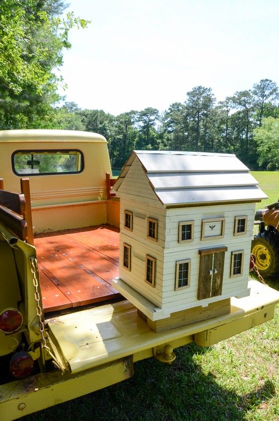 an old truck with a house on the back