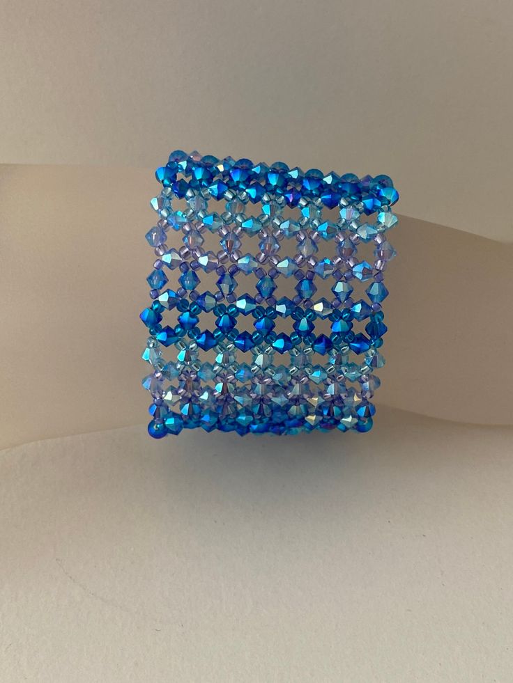 Crystal, Crystal bracelet, woman, extra large, gradation of blue, fashion jewelry, luxury A breathtaking width... Width: 4.5 cm Length: 14.8 cm or other You can ask me the length that you wish in order to adapt it perfectly to your wrist. Clasp 4 rows motif leaves 9x25 mm rhodium plated Material: crystal, rocailles, rhodium clasp Crystal is glass with a refractive index of 1.545 or higher. Unlike glass, crystal has more clarity, more brightness. Blue Crystal Bracelets For Formal Occasions, Blue Crystal Bracelet For Party, Blue Crystal Bracelet For Formal Occasions, Elegant Blue Crystal Beaded Bracelets, Elegant Light Blue Bracelets For Party, Elegant Blue Beaded Crystal Bracelet, Elegant Light Blue Bracelet For Party, Elegant Blue Handmade Bracelets, Blue Elegant Beaded Bracelets For Formal Occasions