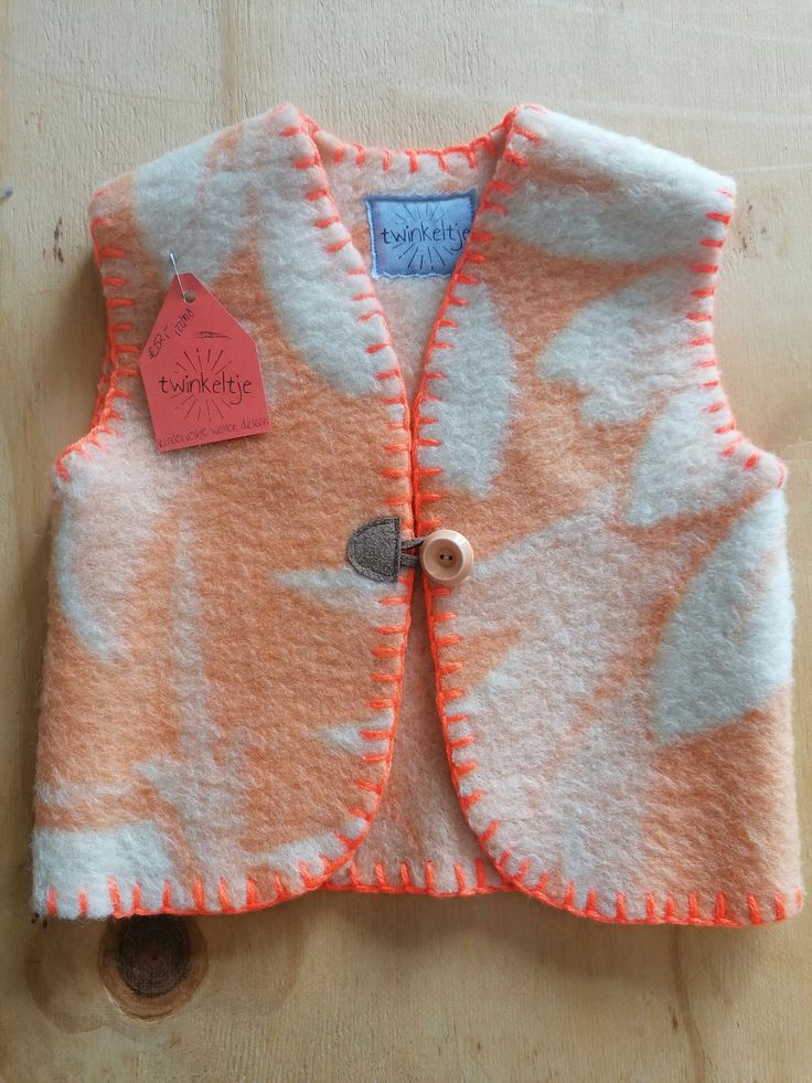 an orange and white vest with a tag on it