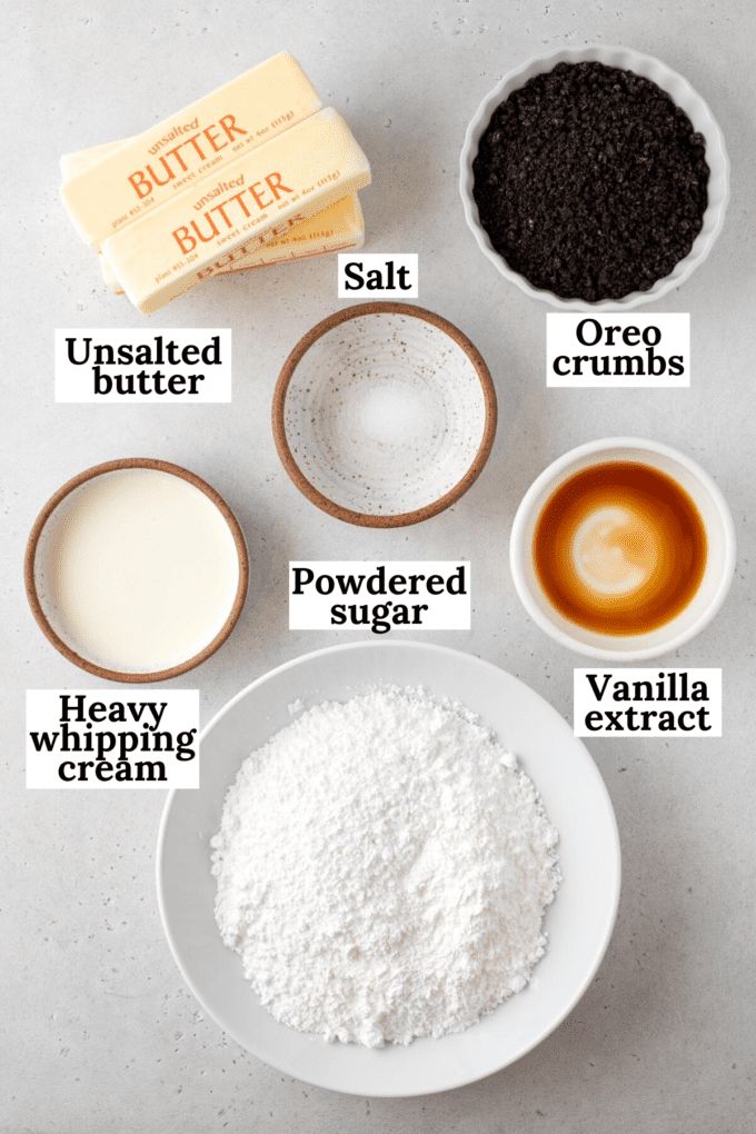 ingredients to make chocolate peanut butter cookies laid out on a white counter top with labels