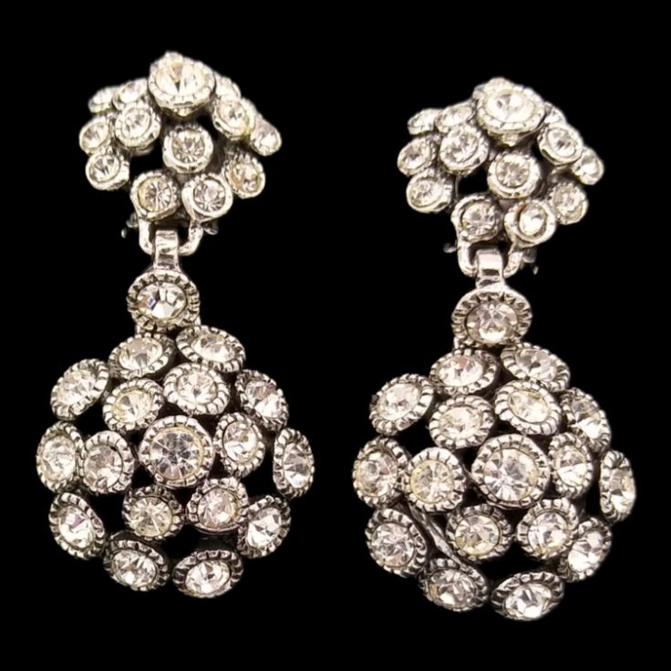 Dangly Rhinestone Earrings, Clip Earrings with Clear Rhinestones! These dazzling clip earrings feature brilliant clear rhinestone chatons, all paste set in silver tone metal. They are in excellent vintage condition, clip mechanisms are perfect! They measure 1 7/8 by 7/8 inches of pure sparkle! Crystal Clip-on Earrings With Sparkling Stones For Formal Occasions, Formal Sparkling Crystal Clip-on Earrings, Silver Crystal Clip-on Earrings For Formal Events, Crystal Clip-on Earrings For Formal Occasions, Formal Crystal Clip-on Earrings With Bling, Formal Crystal Clip-on Earrings, Formal Jeweled Drop Clip-on Earrings, Formal Crystal Bling Clip-on Earrings, Silver Diamond Clip-on Earrings For Evening