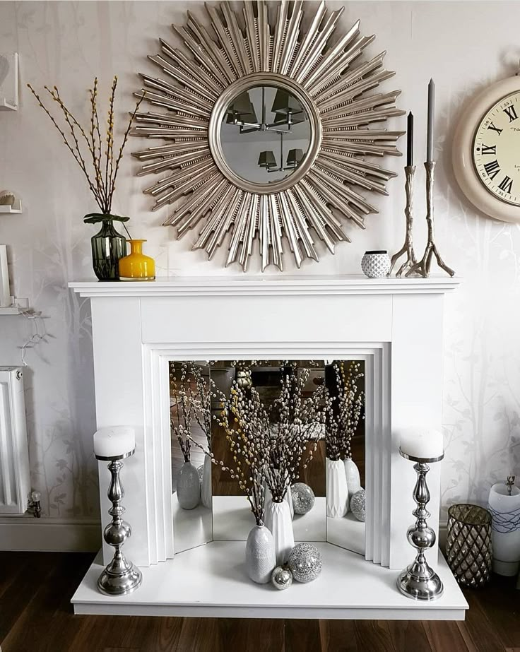 a living room with a fire place and clock on the wall next to it's mantle