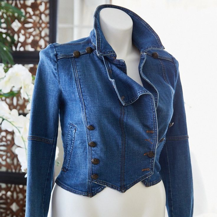 a mannequin wearing a blue jean jacket with buttons on the front and back