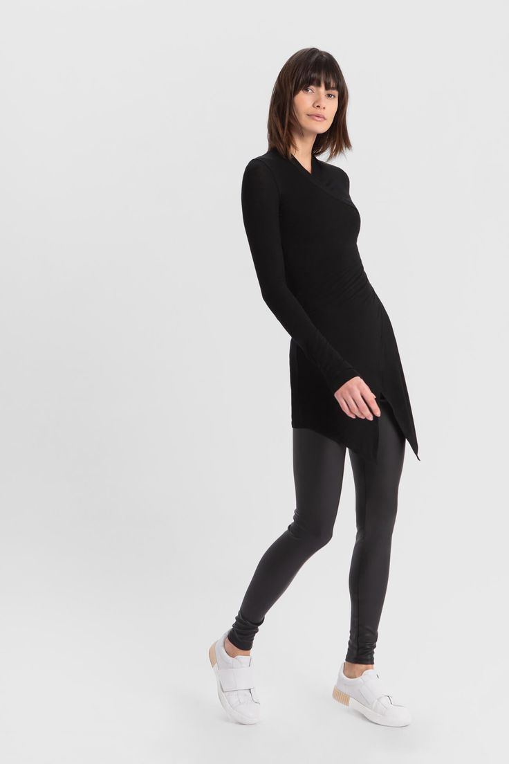 Our Morgan Tunic is the effortlessly elegant statement top you can dress up or down. Featuring a high v-neck and kimono-inspired faux wrap silhouette that allows for movement with ease, she's crafted from our soft, lightweight European sheer jersey, which is high stretch while never losing form. Pair her with skinny jeans and sneakers for a head-turning, yet laid-back look.[SPLIT] Ariane is 5'10.5" (179 cm) tall, wearing size XS. Christina, in black, is 5'9" (175 cm) tall, wearing size XL. Total Wrap Tunic, Refined Fashion, Faux Wrap Top, Wool Coats, Extra Long Sleeves, Sheer Material, Tunic Shirt, Wrap Top, Denim Top