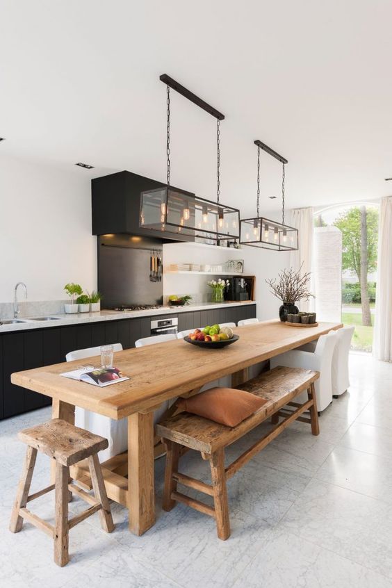 a large wooden table sitting in the middle of a kitchen