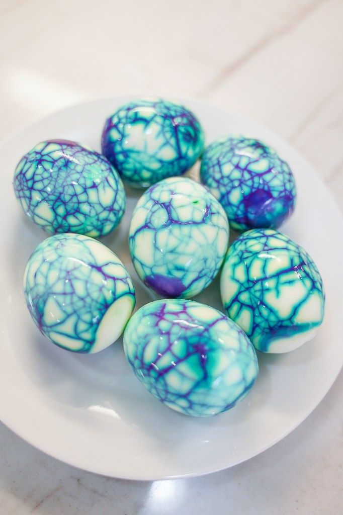 blue and white marbled chocolate eggs on a white plate, ready to be eaten