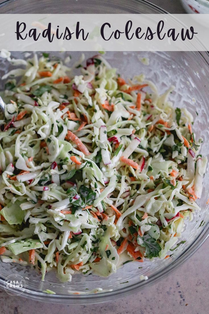 a glass bowl filled with coleslaw and carrots